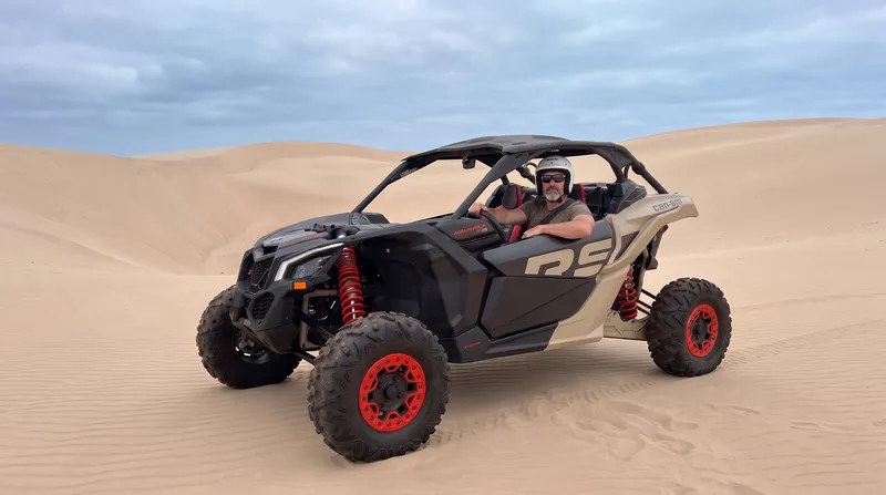Rider in sunglasses next to a Maverick on Lancelin sand