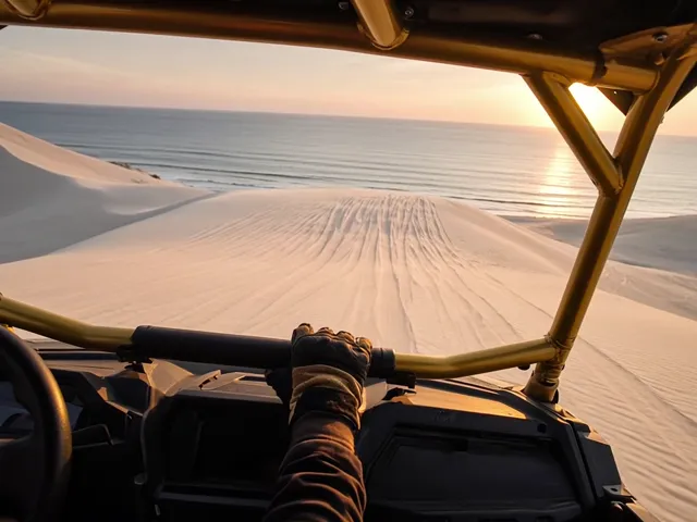 Rider's view cresting a dune at sunset